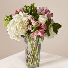 Pink and white mixed bouquet in a clear glass vase