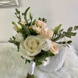 Bouquet of cream and blush roses with greenery