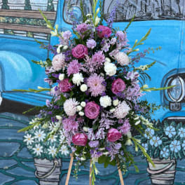 Tall pink and lavender floral spray on a wooden easel