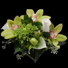 Green and white bouquet with orchids and calla lily in a clear wrap