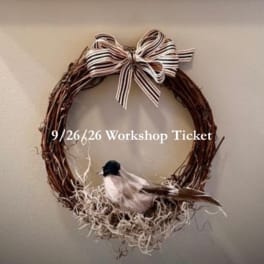 Twig wreath with a striped bow and a small bird decoration