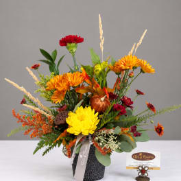 Autumn floral arrangement with chrysanthemums in a black vase