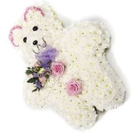 White teddy bear made of flowers with pink accents and a purple bow
