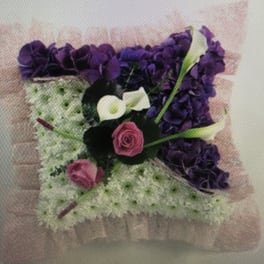 Purple and white floral arrangement with pink roses and calla lilies