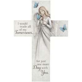 Cross-shaped memorial plaque with a woman and blue butterflies