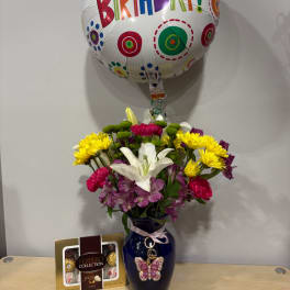 Mixed bouquet in a blue vase with a birthday balloon and chocolate box