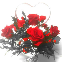 Red roses and carnations in a silver vase with a heart-shaped handle