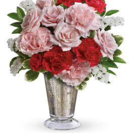 Pink roses and red carnations in a silver vase