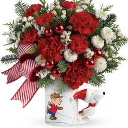 Red carnations and white mums in a Snoopy mug with a striped ribbon