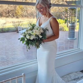 Bride holding a white and green bouquet