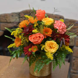 Mixed bouquet of roses and chrysanthemums in a gold vase