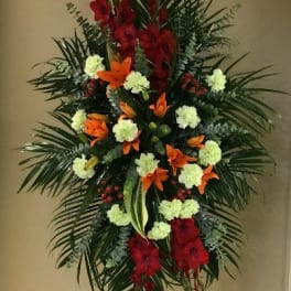 Tall standing floral spray with red, orange, and pale green flowers