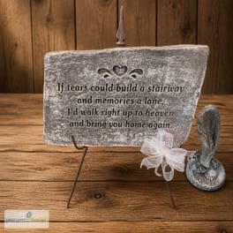 Memorial plaque on a metal stand with a small angel figurine
