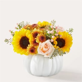 Sunflower and rose arrangement in a white pumpkin vase