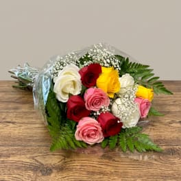 Bouquet of multicolored roses with baby's breath and fern foliage