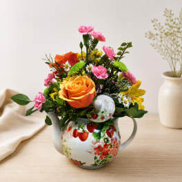 Mixed bouquet in a strawberry-patterned ceramic teapot