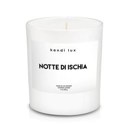 White scented candle in a glass jar with a printed label