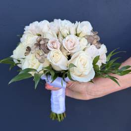 White and blush rose bridal bouquet with greenery and ribbon wrap