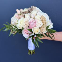 Wedding bouquet of pink and white roses with gold fan accents