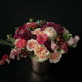 Mixed pink and cream bouquet in a dark vase
