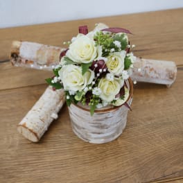 Small bouquet of white roses in a birch-style container