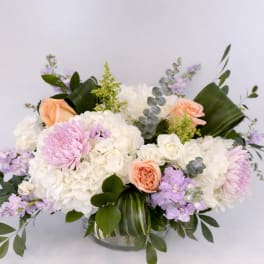 Bouquet of white and pastel flowers in a glass vase