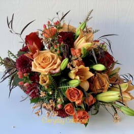 Mixed bouquet with orange and red roses in a basket
