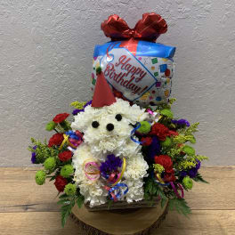 Birthday flower arrangement with a balloon topper and colorful blooms