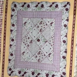 Floral patchwork quilt with pink and burgundy rose prints