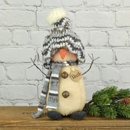 Decorative penguin figurine wearing a knit hat and scarf