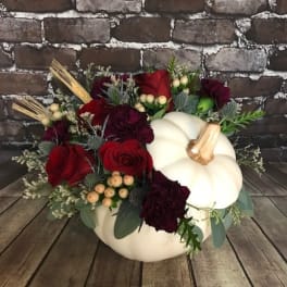 Pumpkin-shaped arrangement with red roses and burgundy flowers