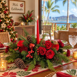 Red rose centerpiece with a tall candle, pinecones, and holiday greenery
