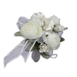 White floral corsage with silver ribbon and pearl accents