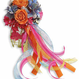 Orange roses with blue hydrangeas and long colorful ribbons
