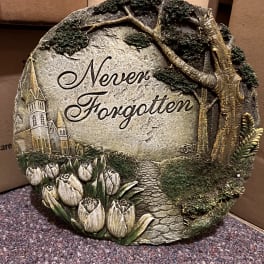 Decorative stone plaque with tulips and the words "Never Forgotten"