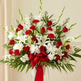 Red and white floral standing arrangement with a red ribbon