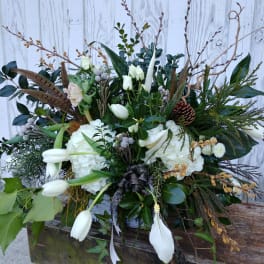 Large white floral arrangement with tulips, hydrangeas, and branches