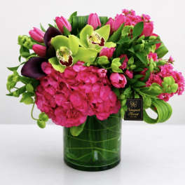 Pink and green floral arrangement in a glass vase