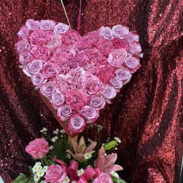 Heart-shaped pink rose arrangement with a smaller mixed bouquet below