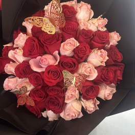 Bouquet of red and pale pink roses with butterfly decorations