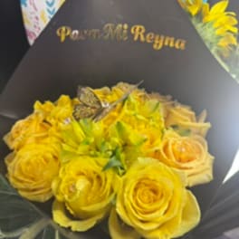 Yellow rose bouquet wrapped in black paper with a butterfly decoration