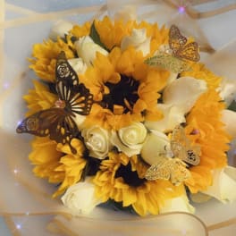 Bouquet of yellow sunflowers and white roses with butterfly decorations