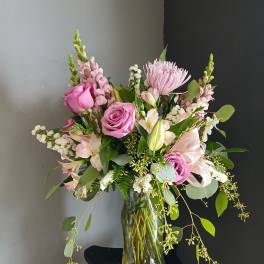Pink mixed flower bouquet in a clear glass vase