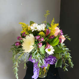 Mixed bouquet in a glass vase with white, pink, and yellow flowers