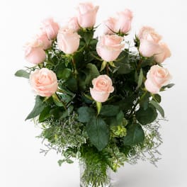 Bouquet of pale pink roses in a clear glass vase