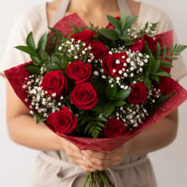 Bouquet of red roses with white baby's breath in red wrap