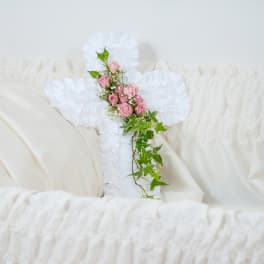 White casket spray with pink roses and ivy