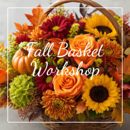 Fall flower basket with roses, sunflowers, and chrysanthemums in a wicker basket