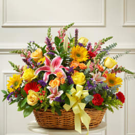 Colorful mixed flower basket with roses, lilies, and daisies