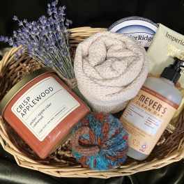 Gift basket with a candle, soap, lotion, nuts, and dried lavender
